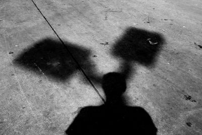 Low section of person standing on shadow