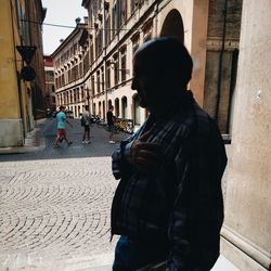 Rear view of woman standing on city street