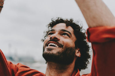 Close-up of smiling young man looking up