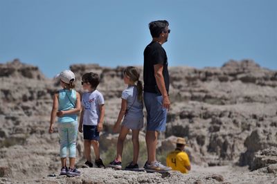 Full length of friends standing on land