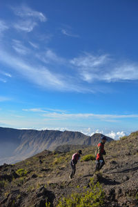 People on mountain against sky. tambora mountain