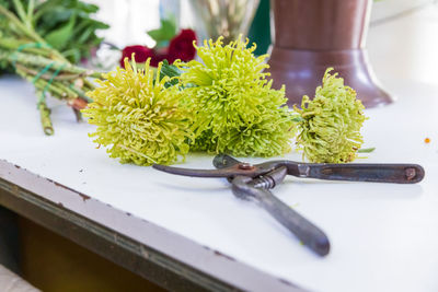 The florist at work. he cuts flowers and prepares an arrangement or bouquet with yellow flowers.