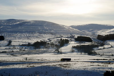 Scenic view of mountains against sky during winter