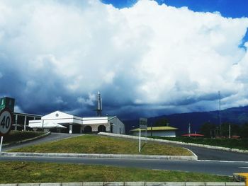 Country road against cloudy sky