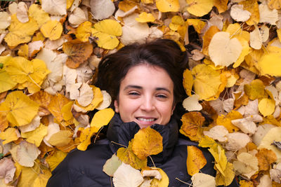 Close-up of woman holding yellow flower