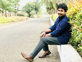 Portrait of smiling young man sitting outdoors
