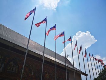 Low angle view of flags against sky