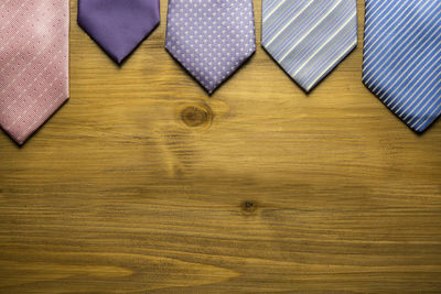 Directly above shot of colorful neckties arranged on wooden table