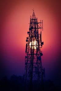 Silhouette crane against sky during sunset