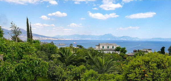 Scenic view of sea and mountains against sky