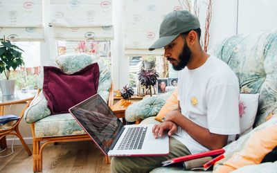 Side view of two people sitting on table