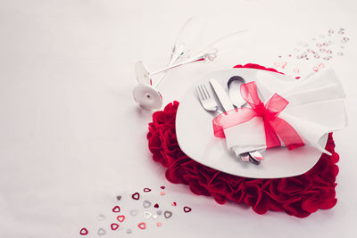 High angle view of heart shape on table against white background
