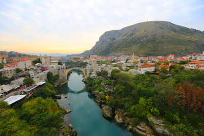 High angle view of townscape by mountain against sky