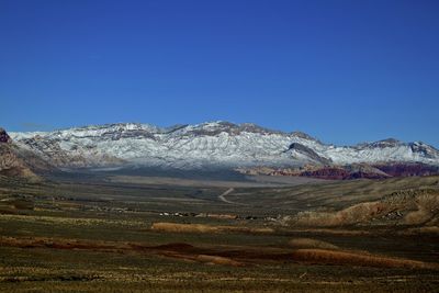 Scenic view of mountains against clear blue sky