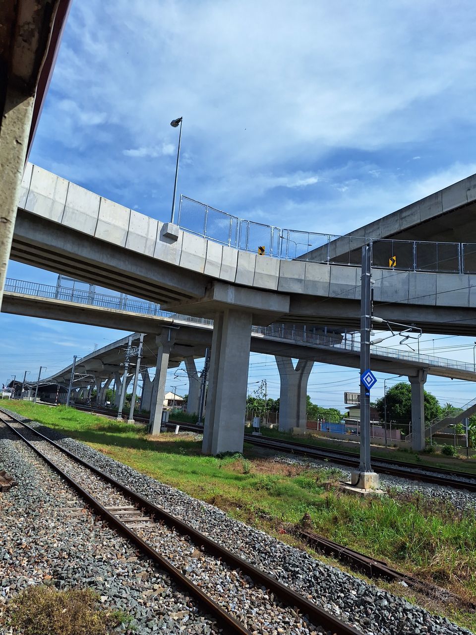 architecture, built structure, urban area, transport, building exterior, day, sky, nature, cloud, city, low angle view, outdoors, transportation, no people, blue, landmark, building, skyscraper, public transport, bridge