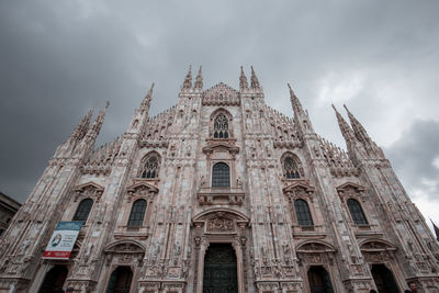 Low angle view of church against clouds