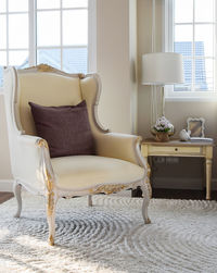 Empty chairs on rug at home