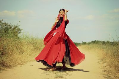 Woman with umbrella standing on land