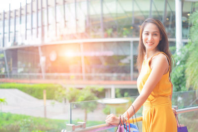 Portrait of a smiling young woman standing outdoors