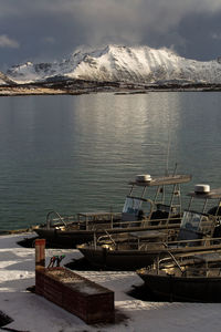 Scenic view of lake by mountains against sky