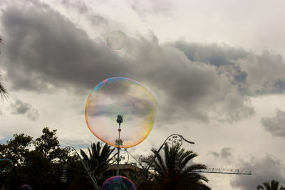 Low angle view of bubbles against sky