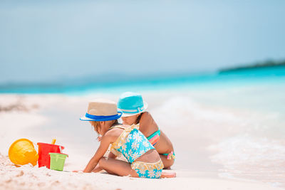 Full length of child sitting on beach