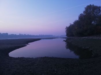 Scenic view of lake against sky at sunset