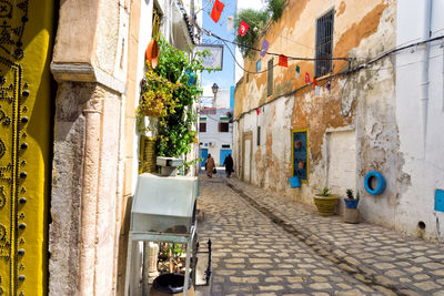 Narrow street amidst buildings in city