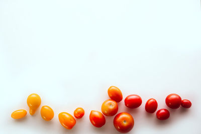 High angle view of tomatoes against white background