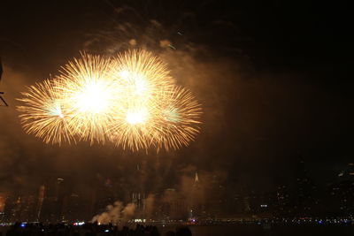 Low angle view of firework display at night