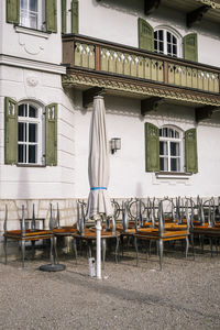 Empty chairs and tables outside building
