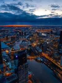 High angle view of illuminated buildings against sky at sunset