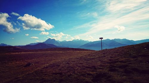 Scenic view of mountains against cloudy sky