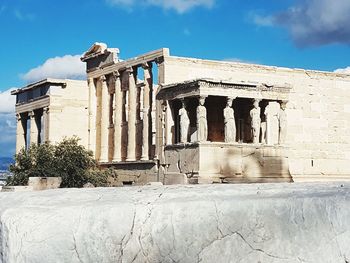 Low angle view of historical building against cloudy sky