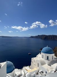 Panoramic view of sea and buildings against sky