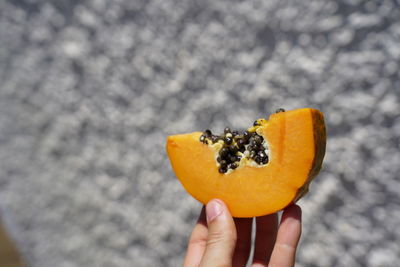 Cropped image of person holding fruit