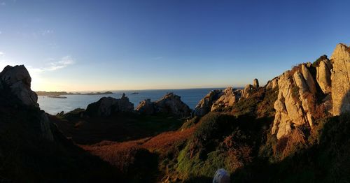 Scenic view of sea and cliff against sky