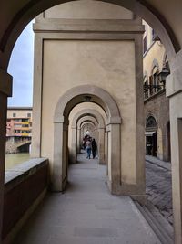 People walking in corridor of building