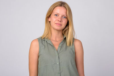 Portrait of a smiling young woman over white background