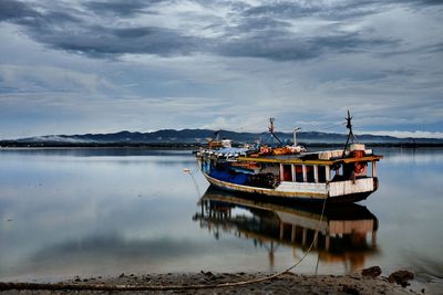 Ship moored on sea against sky