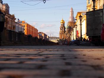 View of city street and buildings against sky