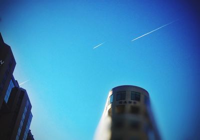 Low angle view of buildings against clear blue sky