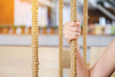 Cropped image of hand holding rope