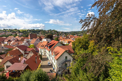 View of the red roofs of schmalkalden, thuringia from above with green trees in the foreground