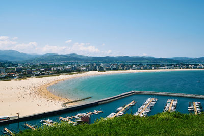 High angle view of sea and cityscape against sky