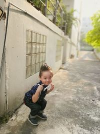 Full length of cute baby boy against building