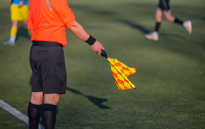 Low section of man playing soccer