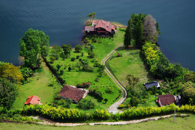 Directly above shot of houses on green land by river