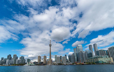 Modern buildings in city against cloudy sky