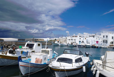 Boats moored in sea against sky